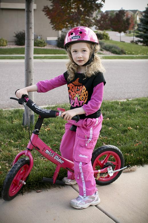 older girl on mini glider bike